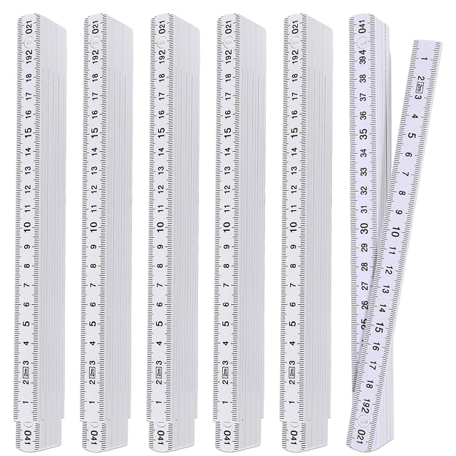 Five white plastic folding rules from prota, one unfolded and four stacked